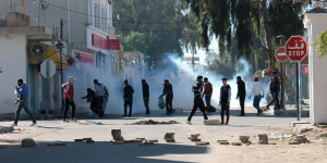 Tunisian protesters take to the streets in the southern town of Kasserine , Tunisia, and clash with riot police during a protest against a new tax on vehicles, Wednesday, Jan. 8, 2014. Protesters called the government the "assassin of our dreams," complaining that little has changed since the country's reviled leader was ousted in 2011. (AP Photo / Mouldi Kraiem)